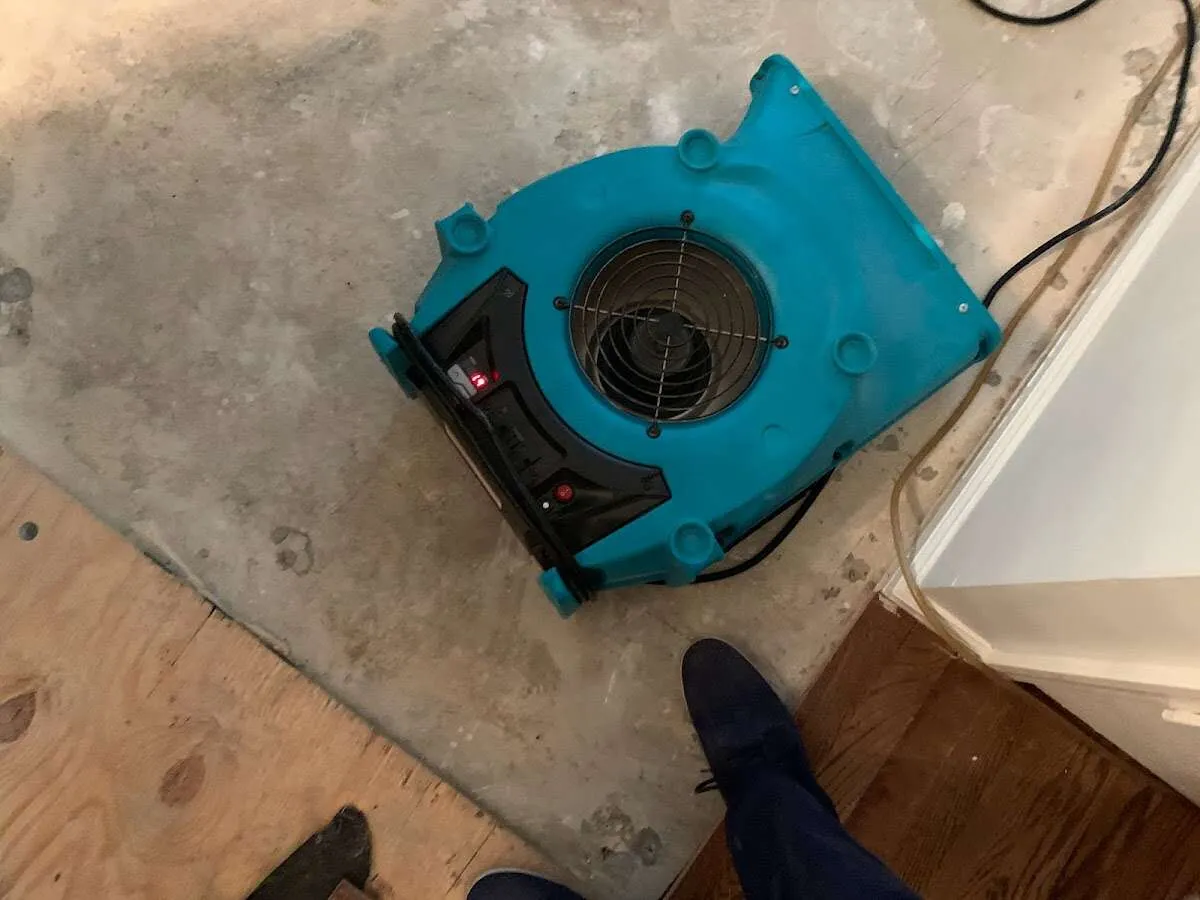 Air mover drying subfloor during Leak Detection & Repair in Northbrook